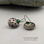 Aarini scarlet sparkle earrings with red crystal ladybug charm detailing
