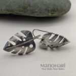 Meher leaf charm earrings with oxidised Monstera cutwork detailing