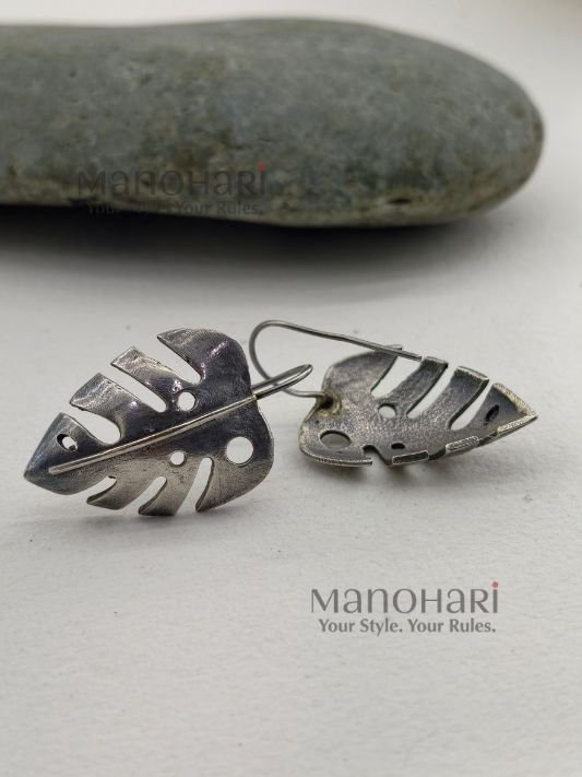 MN-ER-MLCE-MEH-01_1 Meher leaf charm earrings with oxidised Monstera cutwork detailing