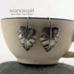 Meher leaf charm earrings with oxidised Monstera cutwork detailing