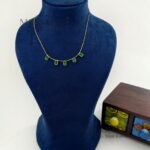 Aarini emerald royale necklace with elegant gemstone and gold detailing