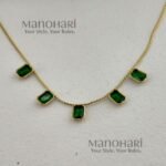 Aarini emerald royale necklace with elegant gemstone and gold detailing