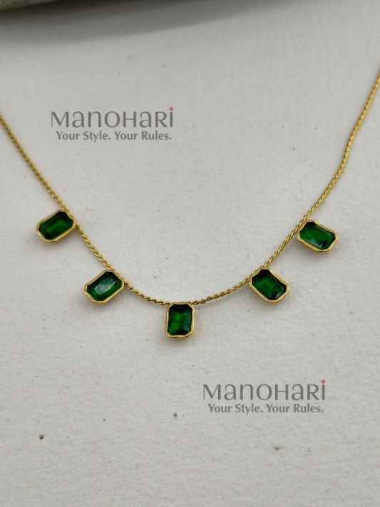 Aarini emerald royale necklace with elegant gemstone and gold detailing