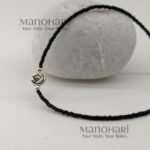 Naina Blossom Bead Anklet featuring elegant black bead detailing and a delicate floral charm in a silver replica design
