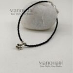 Naina Blossom Bead Anklet featuring elegant black bead detailing and a delicate floral charm in a silver replica design
