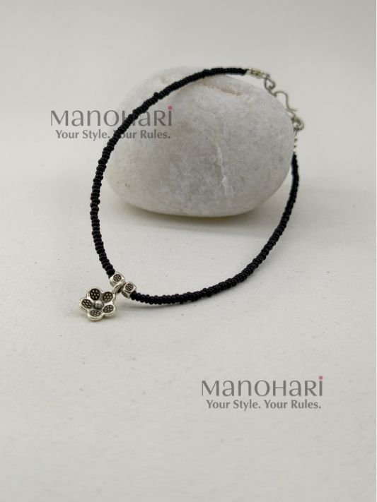 Naina Blossom Bead Anklet featuring elegant black bead detailing and a delicate floral charm in a silver replica design