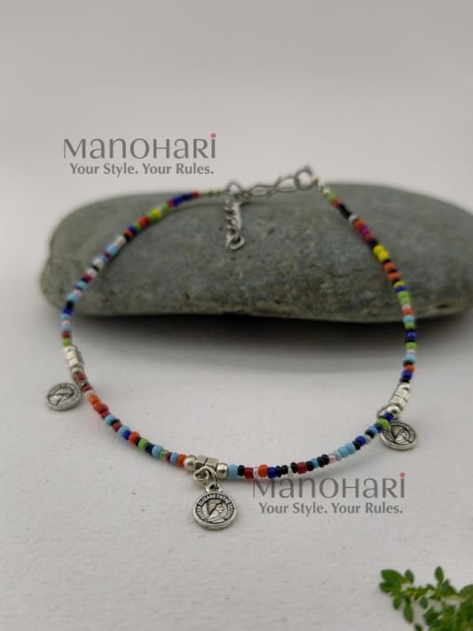 Naina Silver Blossom Anklet featuring oxidised flower charms, colorful multi-bead detailing, and a silver-plated finish for an elegant boho-inspired look
