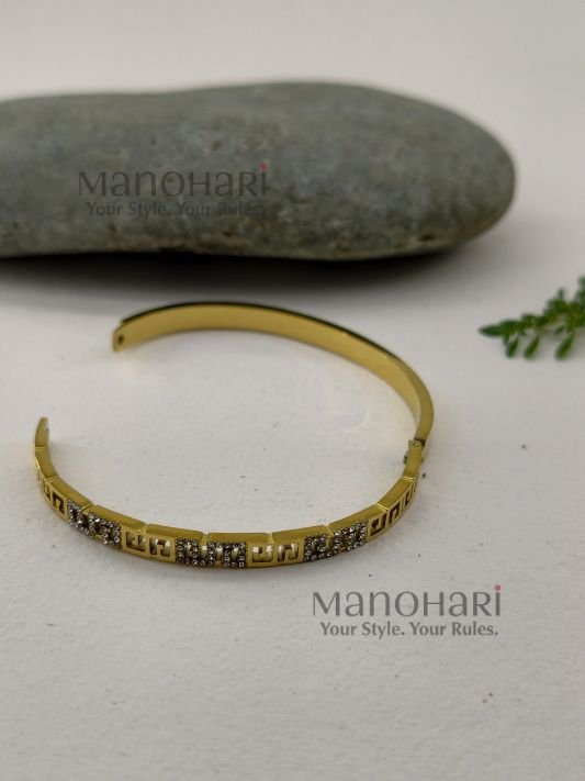 Ruhani Imperial Key Bangle featuring an iconic Greek Key meander pattern with a premium anti-tarnish finish and timeless geometric elegance
