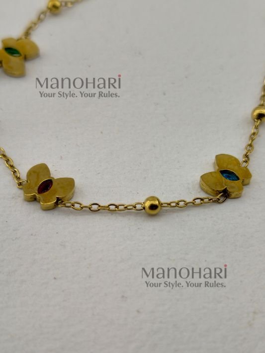 MN-BR-ACCB-AUR-01_2 Aurelia Clover Charm Bracelet featuring a delicate clover motif with sparkling multistone accents and an elegant anti-tarnish finish