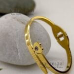 Aarini Tiny Charm Bracelet for babies crafted in 18K gold-plated 316L stainless steel featuring a delicate openable bangle design