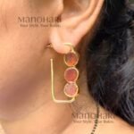 Aarini Rawstone Elegance Earrings featuring natural raw stones set in a gold-polished brass frame with a contemporary geometric design
