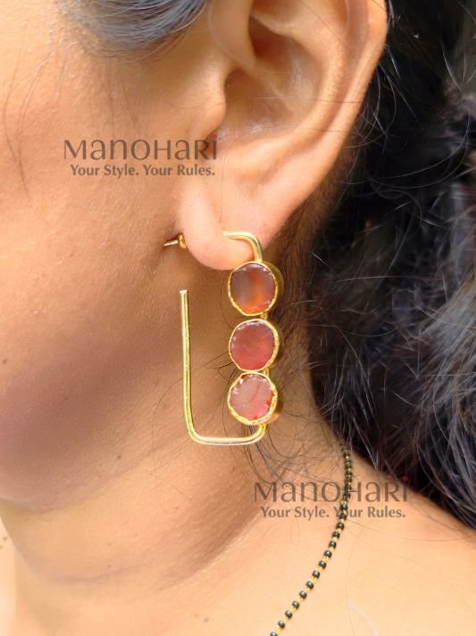 Aarini Rawstone Elegance Earrings featuring natural raw stones set in a gold-polished brass frame with a contemporary geometric design