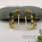 Aarini Rawstone Elegance Earrings featuring natural raw stones set in a gold-polished brass frame with a contemporary geometric design