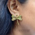 Meher dragonfly charm studs featuring a chic dragonfly design with a radiant gold-tone finish