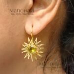 Meher Sunray Charm Hoops featuring a radiant sun-inspired charm crafted in raw brass with a classic hoop design