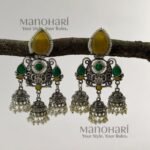 Naina Aarna Grace Jhumkas featuring intricately carved stones and elegant jhumki domes in a traditional statement design