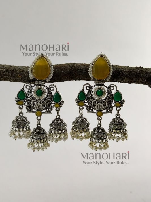 Naina Aarna Grace Jhumkas featuring intricately carved stones and elegant jhumki domes in a traditional statement design