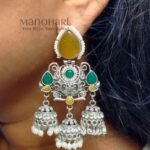Naina Aarna Grace Jhumkas featuring intricately carved stones and elegant jhumki domes in a traditional statement design