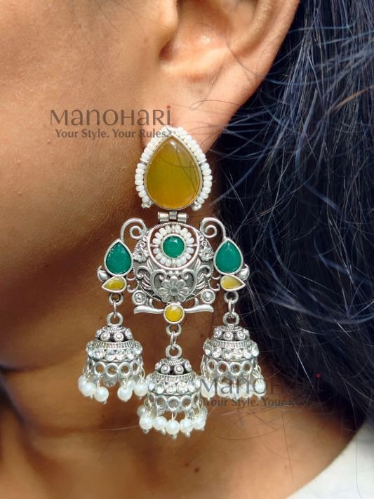Naina Aarna Grace Jhumkas featuring intricately carved stones and elegant jhumki domes in a traditional statement design