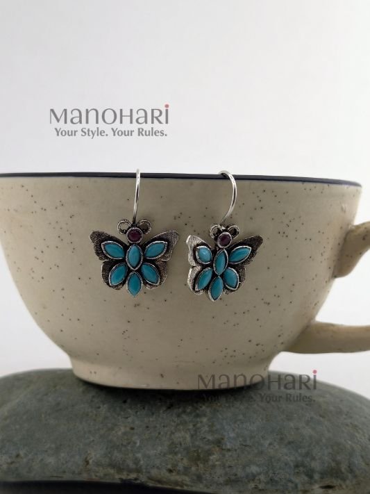 Naina Butterfly Bloom Earrings featuring a delicate butterfly design with stone accents and an elegant oxidised silver finish