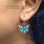Naina Butterfly Bloom Earrings featuring a delicate butterfly design with stone accents and an elegant oxidised silver finish