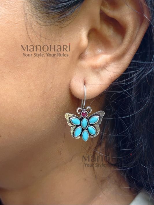 Naina Butterfly Bloom Earrings featuring a delicate butterfly design with stone accents and an elegant oxidised silver finish