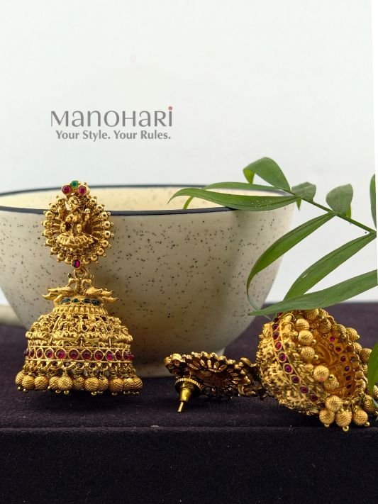 Lakshmi Grace Kemp Jhumka crafted from premium brass with a matte gold polish, featuring a Goddess Lakshmi motif, clustered pearls, and traditional Kemp temple design for women.