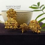 **Shri Lakshmi Temple Earrings crafted from premium copper, brass, and metal alloy with a high gold polish, featuring an intricate Goddess Lakshmi motif and elegant jhumka design for women.**