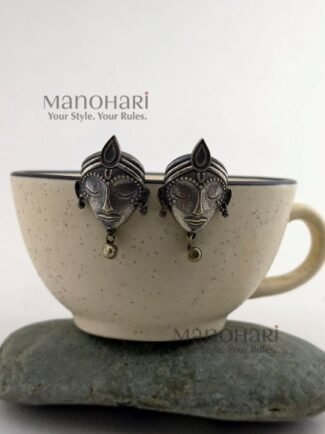 Ziya Silver Elegance Studs featuring an intricately carved divine face motif with an oxidised silver-tone finish and heritage-inspired craftsmanship