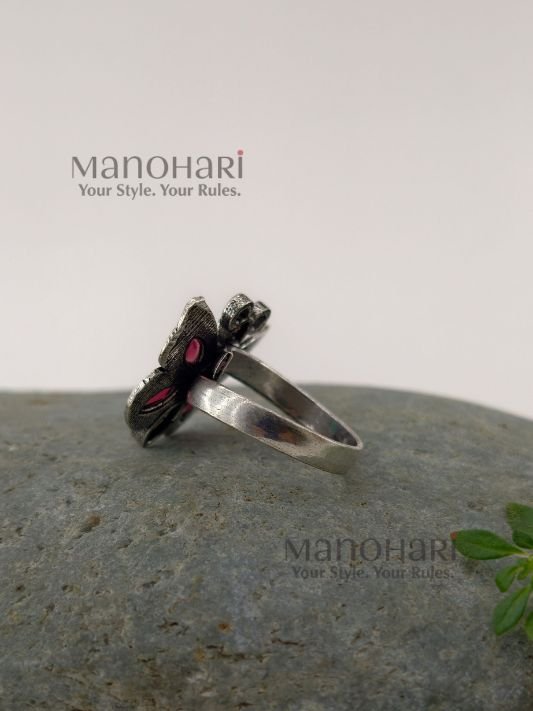 Ruhani butterfly jewel ring with red and green stones in an oxidised silver finish