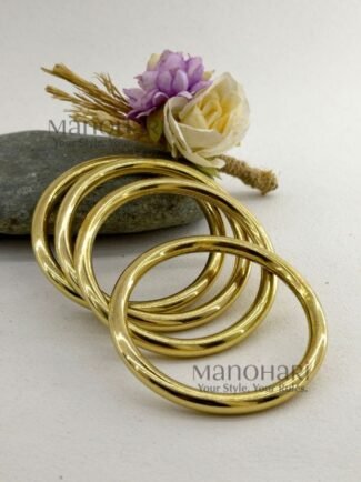 **Aarika Heritage Brass Bangles Set featuring four handcrafted premium brass bangles with a radiant golden finish, artisan detailing, and a classic 6 cm inner diameter for timeless ethnic elegance.**
