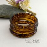 **Mariska Marble Resin Bangle Set featuring four lightweight resin bangles with an elegant brown marble pattern, a smooth polished finish, and a comfortable 6 cm inner diameter for modern everyday style.**