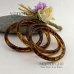 **Mariska Marble Resin Bangle Set featuring four lightweight resin bangles with an elegant brown marble pattern, a smooth polished finish, and a comfortable 6 cm inner diameter for modern everyday style.**
