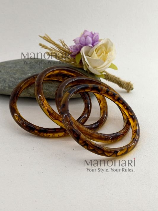 **Mariska Marble Resin Bangle Set featuring four lightweight resin bangles with an elegant brown marble pattern, a smooth polished finish, and a comfortable 6 cm inner diameter for modern everyday style.**