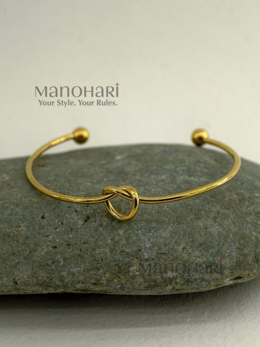 **Aarunya Infinity Knot Bracelet featuring a premium gold-plated finish with an elegant infinity knot design and adjustable fit for women.**