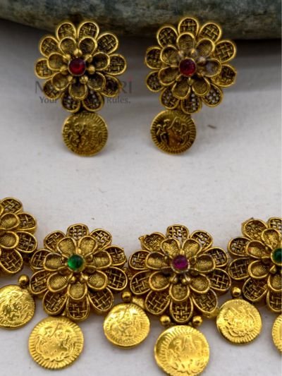 **Gauri Coin Heritage Choker Set crafted from premium alloy with a radiant gold-plated finish, featuring traditional coin work, sparkling artificial stones, and matching earrings with an adjustable thread for women.**