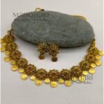 **Gauri Coin Heritage Choker Set crafted from premium alloy with a radiant gold-plated finish, featuring traditional coin work, sparkling artificial stones, and matching earrings with an adjustable thread for women.**