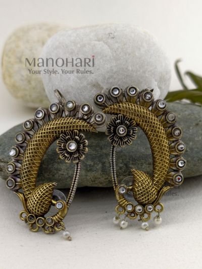 **Mayurika Peacock Pearl Ear Cuff crafted from premium brass with an elegant two-tone finish, featuring an intricate peacock design adorned with shimmering stones and delicate pearl accents for a regal traditional look.**