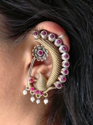 **Mayurika Peacock Pearl Ear Cuff crafted from premium brass with an elegant two-tone finish, featuring an intricate peacock design adorned with shimmering stones and delicate pearl accents for a regal traditional look.**