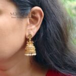 **Aadhira Antique Elegance Earrings crafted from premium brass metal with a radiant High Gold Polished finish, featuring an elegant antique-inspired design adorned with artificial stones for women.**