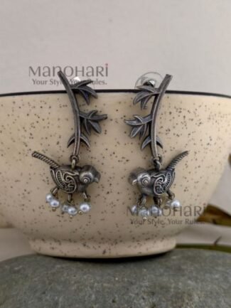 **Avira Bird Leaf Earrings crafted from pure brass with an elegant silver replica finish, featuring an intricate bird and leaf design adorned with delicate glass pearl beads for a graceful nature-inspired look.**