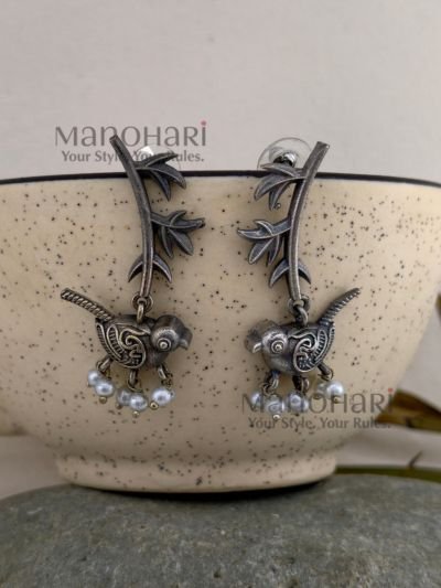 **Avira Bird Leaf Earrings crafted from pure brass with an elegant silver replica finish, featuring an intricate bird and leaf design adorned with delicate glass pearl beads for a graceful nature-inspired look.**