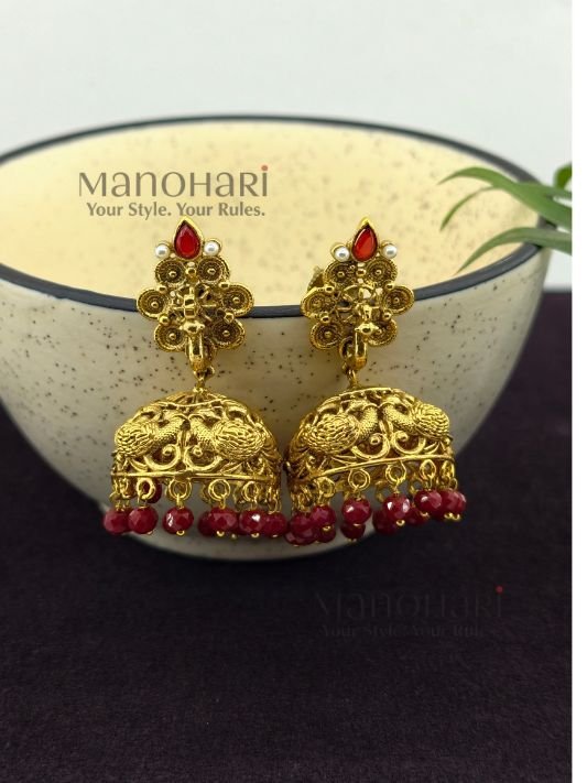 **Mayurika Peacock Heritage Jhumki crafted from premium copper, brass, and metal alloy with a luxurious High Gold, Matte Gold, Silver, or Mehendi Polish finish, featuring an intricately engraved peacock design adorned with artificial stones for women.**
