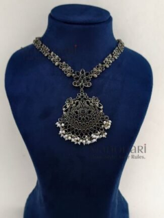 **Varnika Floral Pearl Heritage Necklace crafted from premium brass with a silver replica finish, featuring an intricate floral pendant adorned with elegant black stones, measuring 6 × 5 cm on a 21 cm statement necklace for timeless ethnic elegance.**