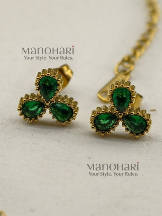 **Juwana Floral Heritage Necklace Set crafted from premium gold-plated metal, featuring radiant emerald green floral daisy motifs, a delicate gold link chain, and matching floral earrings for women.**