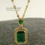 **Emera Emerald Grace Pendant crafted from premium stainless steel with a luxurious gold-plated finish, featuring a radiant emerald green centerpiece and elegant 2.5 cm pendant design for women.**