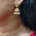 **Aditi Pearl Temple Pendant Set crafted from premium brass and copper metal with a luxurious Matte Gold Polish finish, featuring a 3 cm temple-inspired pendant, matching 3 cm jhumka earrings, clustered pearls, and artificial stones for women.**