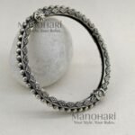 **Aarohi Heritage Silver Bangle crafted from premium brass with an elegant oxidised silver-plated finish, featuring a vintage-inspired openable design and a comfortable 6 cm inner diameter for timeless ethnic elegance.**