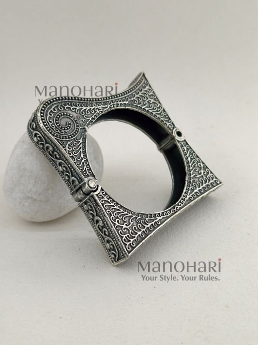 **Zehra Tribal Silver Bangle crafted from premium brass with an elegant oxidised silver-look finish, featuring a traditional Afghani tribal design, adjustable openable style, and a comfortable 5.5 cm inner diameter for timeless ethnic elegance.**