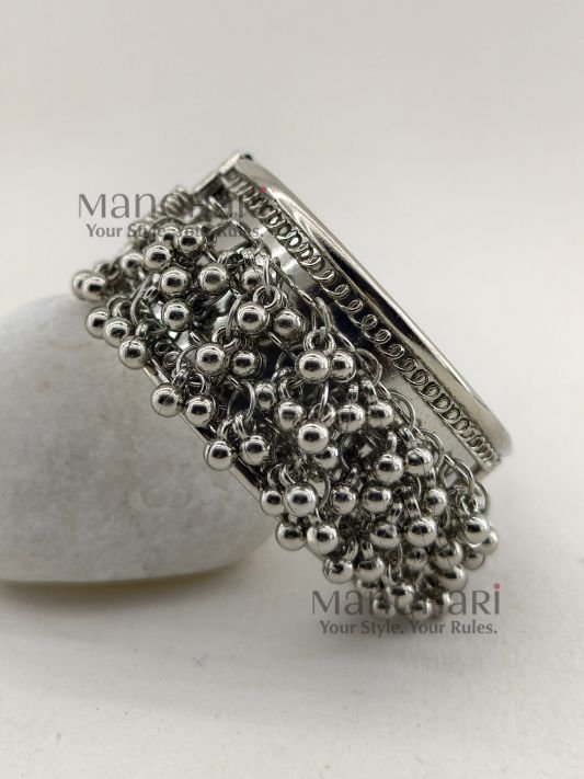 **Aarvi Silver Ghungroo Bracelet crafted from premium alloy metal with an elegant silver-tone finish, featuring delicate ghungroo detailing, an openable fold-over clasp, and a comfortable 6 cm inner diameter, perfect for festive and ethnic styling.**